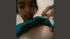 A young woman reveals her unshaven genitalia and breasts in an erotic video