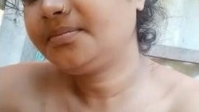 Attractive Indian woman displays her large breasts