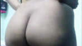 An Indian wife reveals her curvy backside and indulges in playful behavior