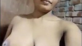 Village girl flaunts her large breasts and pussy