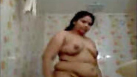 Fat woman's wife oiling her hair naked in the bathroom